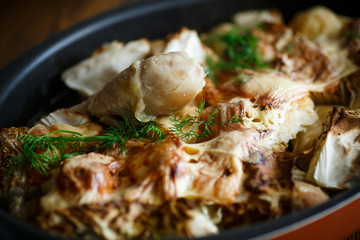 baked chicken legs with pieces of cabbage