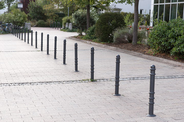 Bollards made of metal on a promenade in a row