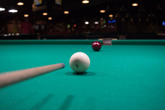Russian billiards player aims to shoot balls with cue