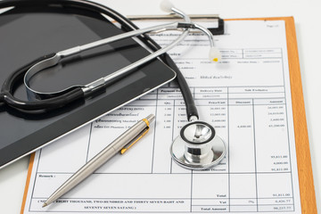Stethoscope on medical billing statement on table, all text is a