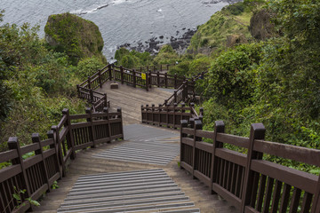 Fototapeta na wymiar Long stairways down the hill,Jeju Island, South Korea.