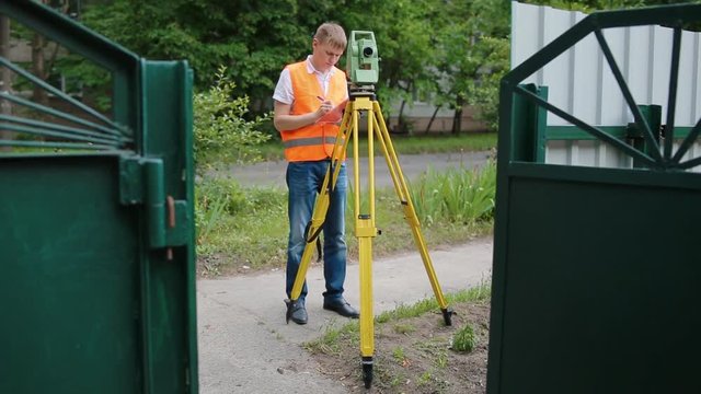 Surveyor at work measuring the distance