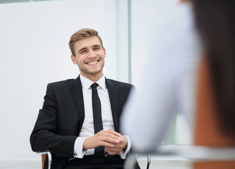 Image of young businessman communicating with his colleague