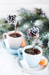 Obraz na płótnie Canvas two tea cups with teabag and xmas tree