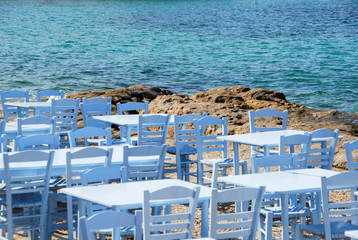 Fototapeta na wymiar Sesseln mit Tischen am Strand von Mykonos