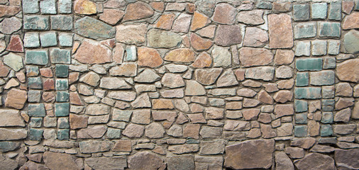 wall of granite boulders of different colors