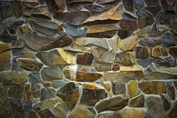 wall of granite boulders of different colors