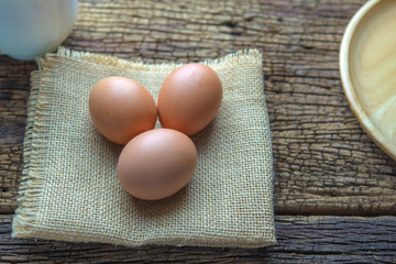 three eggs are bubbles on the background of a hemp sack.