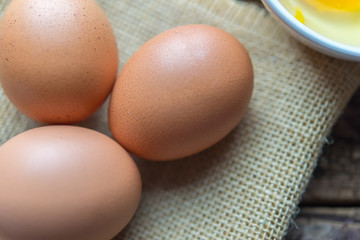 three eggs are bubbles on the background of a hemp sack.