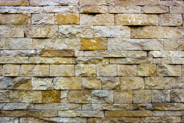 house wall decorated with multi-colored sandstone wall tiles