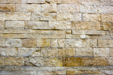 house wall decorated with multi-colored sandstone wall tiles