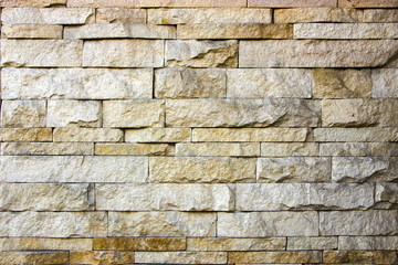 house wall decorated with multi-colored sandstone wall tiles