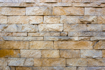 house wall decorated with multi-colored sandstone wall tiles