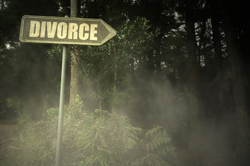 old signboard with text divorce near the sinister forest