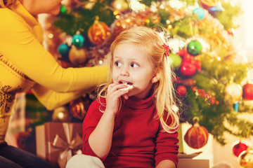 Happy family enjoying decorating Christmas tree.