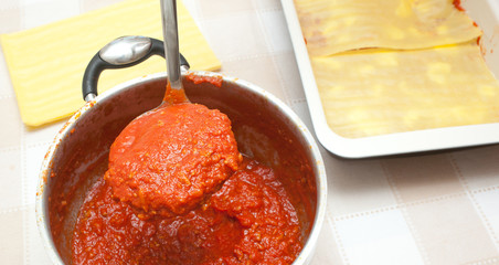 Preparation of homemade lasagna.