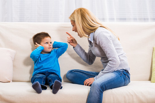 Angry Mother Is Scolding At Her Son.

