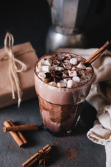 Cocoa or latte or hot chocolate with marshmallow and flavored with cinnamon. On a gray concrete background. Christmas present. Christmas concept. Christmas holiday.