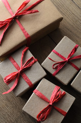 Overhead of Gift Boxes Tied with Red Ribbon on Wood