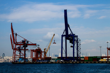 Fototapeta premium Seaport crane and containers with cloudly blue sky