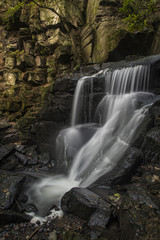 Beautiful waterfall in forest landscape long exposure flowing th