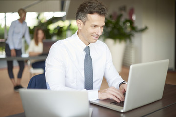 Middle aged businessman with laptop