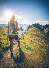 Peaceful view of lone female hiker walking up path