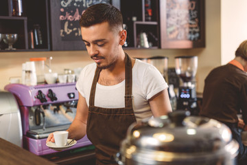 male barista preparing a hot drink