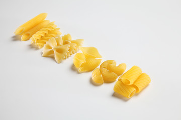 various raw pasta on the white background