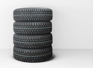 Fototapeta na wymiar Four isolated winter car tires with snow spikes, horizontal position