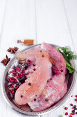 Raw meat for grill, BBQ or cooking with herbs and spices on an iron platter