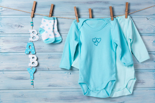 Baby clothes, little socks and word baby on a clothesline