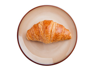 Fresh crispy croissant for breakfast on plate