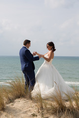 Beautiful bride and groom at the beach