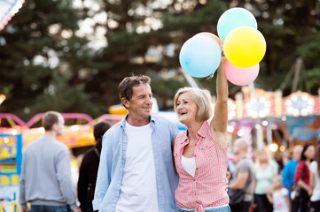 Senior couple having a good time at the fun fair