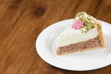 puff pastry in a round white plate on a wooden surface with reflection