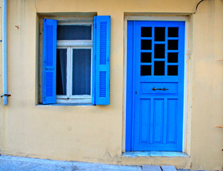 Blue greek shutters window and door in old house