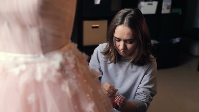 potrait of Fashion Designer Sews a Wedding Dress From Lace