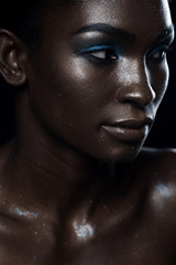 Beauty portrait of dark-skinned girl with make-up glitter
