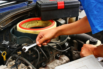 Hand of car mechanic in auto repair