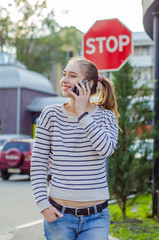 Fototapeta premium Young woman using her phone