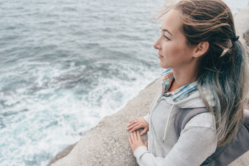 Tourist woman looking at sea