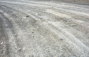 Texture of the stones on the ground. The texture of a rocky dirt road. Mountain road.