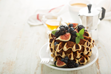 Fluffy breakfast waffles with fresh fruits