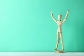 Wooden figure on a green wooden table