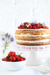 Delicious biscuit cake with berries on cake stand