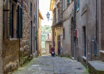 alley of the village with old fashioned scooter