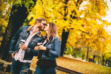 Couple with coffee to go in the park