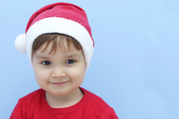 litlle kid dressed as santa claus smiling