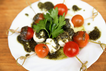 Caprese salad tomato and mozzarella with parsley and herbs on a
